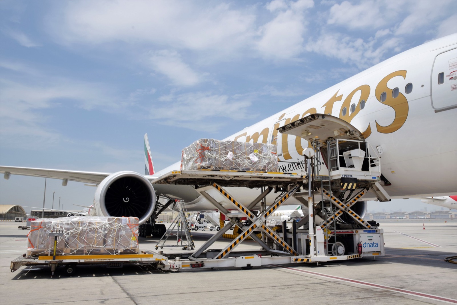 Palletised cargo being loaded onto an Emirates aircraft