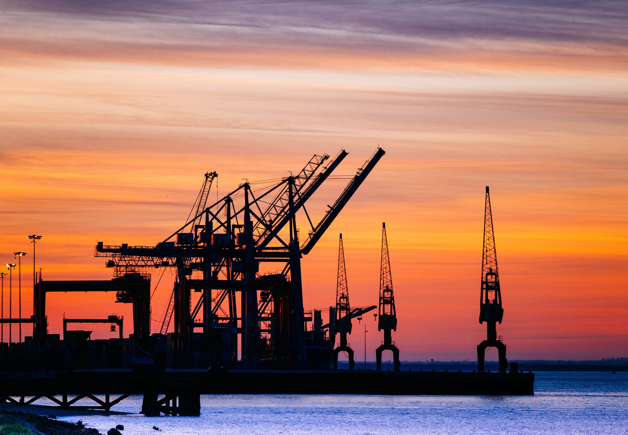 Port cranes at sunset